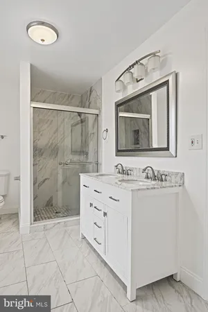 a bathroom with a sink a mirror and shower