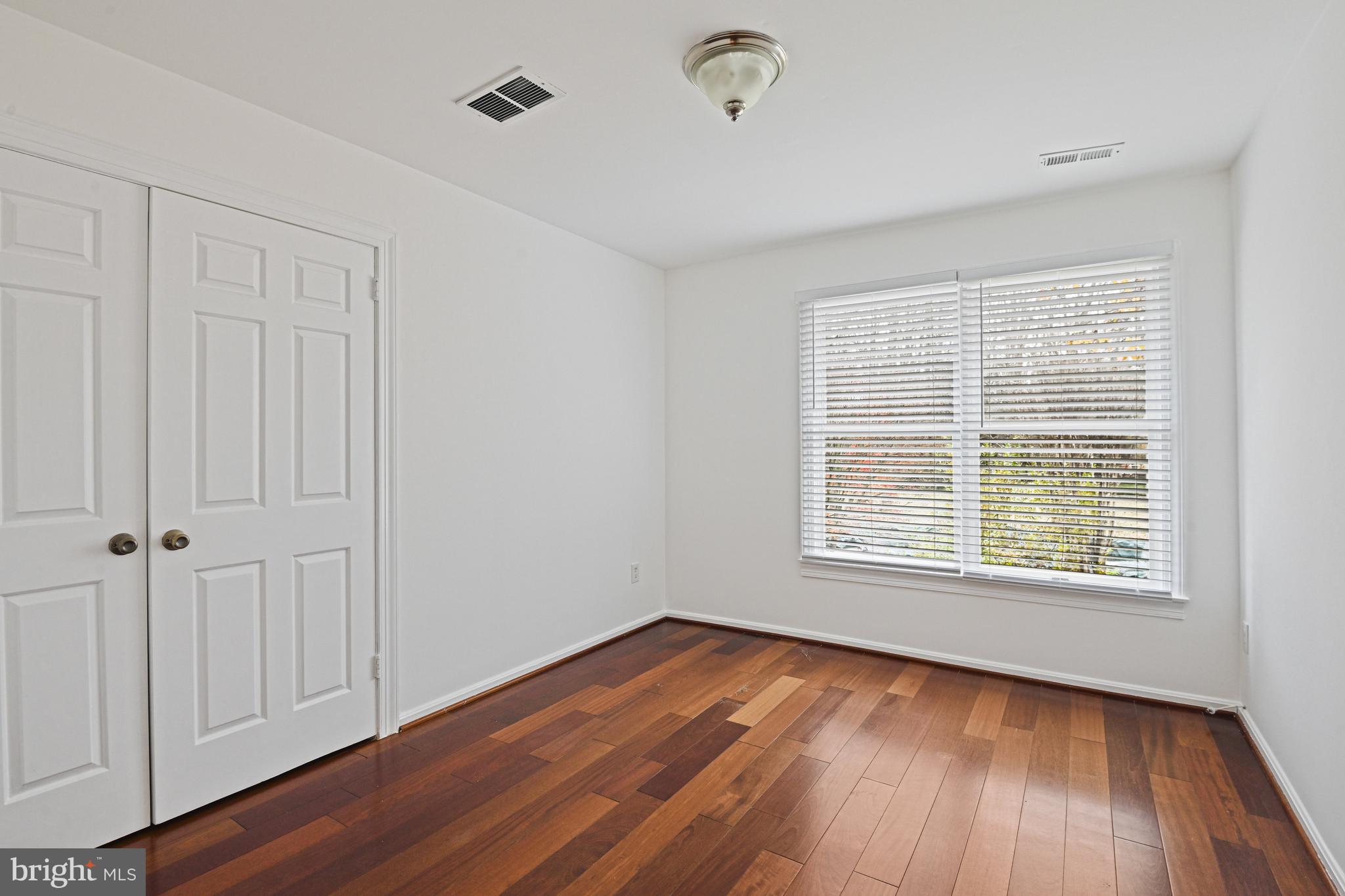 355 Springvale Road Great Falls, VA 22066 - Photo 24 of 37 a view of an empty room with wooden floor and a window