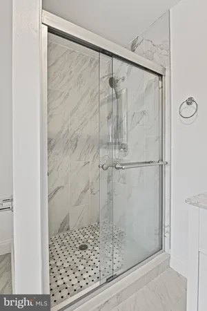 a bathroom with a glass shower door