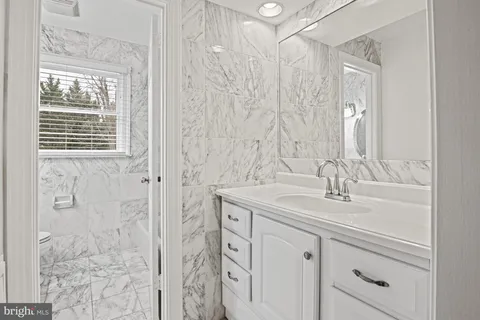a bathroom with a double vanity sink and mirror