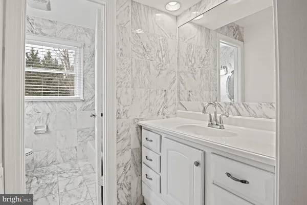 a bathroom with a double vanity sink and mirror