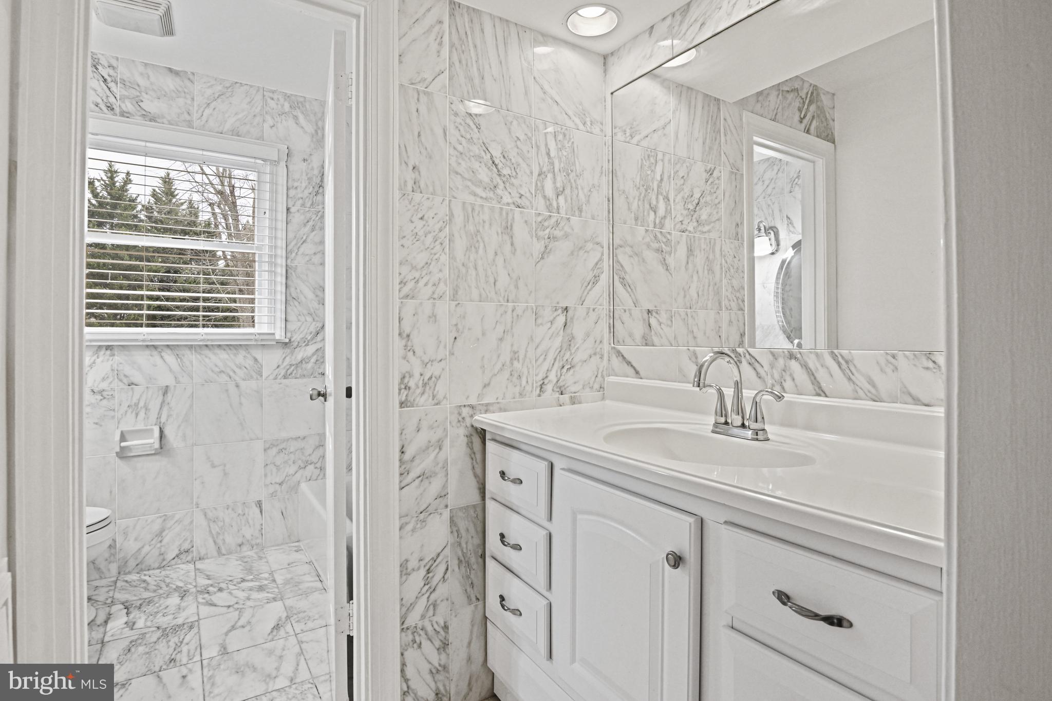 355 Springvale Road Great Falls, VA 22066 - Photo 28 of 44 a bathroom with a double vanity sink and mirror