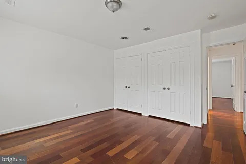 a view of room with wooden floor
