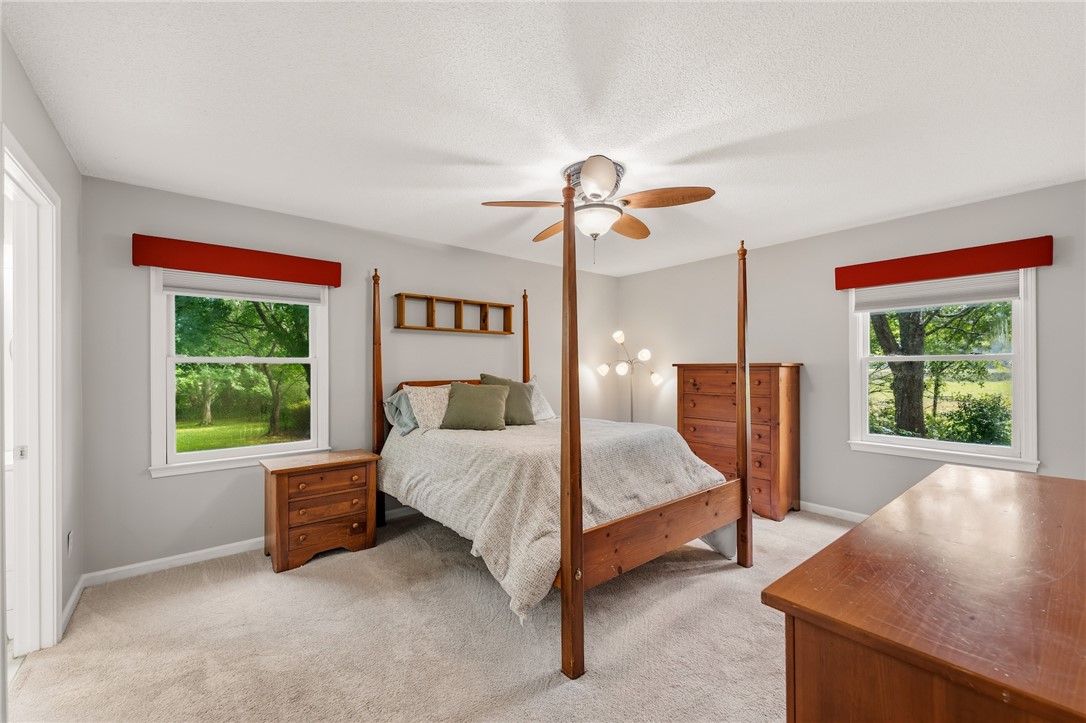 1014 East Queen Street Pendleton, SC 29670 - Photo 24 of 43 Well-lit room features soft carpeting and nature views through large windows.