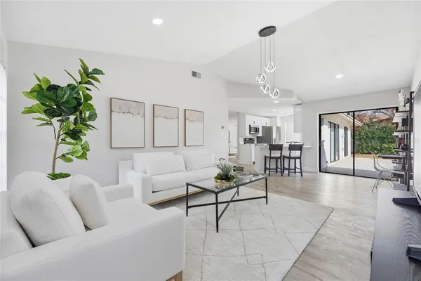 a living room with furniture and a chandelier