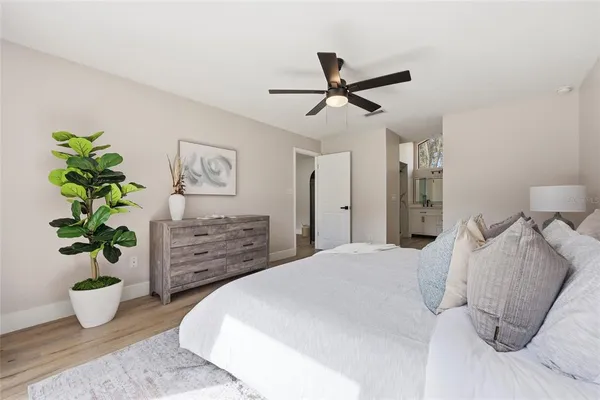 a bed room with a bed and a potted plant