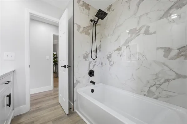 a bathroom with a bathtub and a shower
