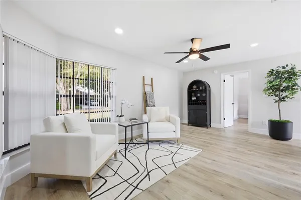 a living room with furniture and a large window