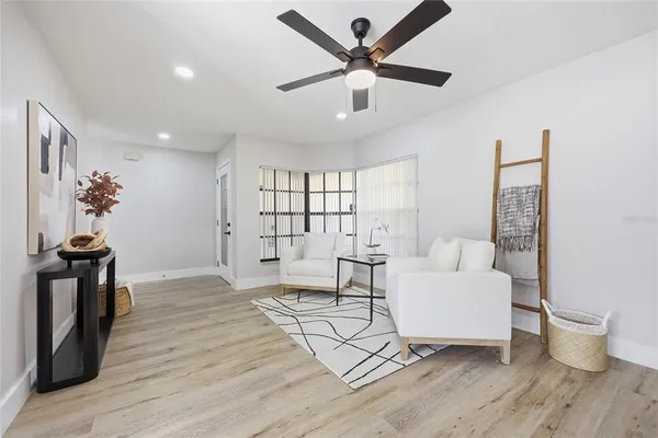 a living room with furniture and a wooden floor