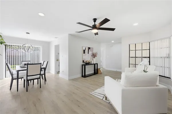 a living room with furniture and a wooden floor