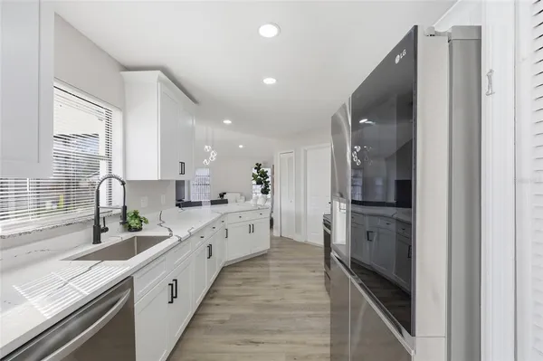 a large kitchen with stainless steel appliances lots of counter top space