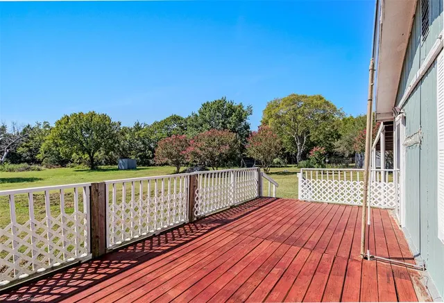 a view of a kitchen with stainless steel appliances granite countertop a sink and cabinets