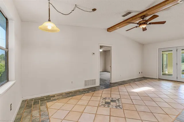 a view of an empty room with a fireplace and a large window