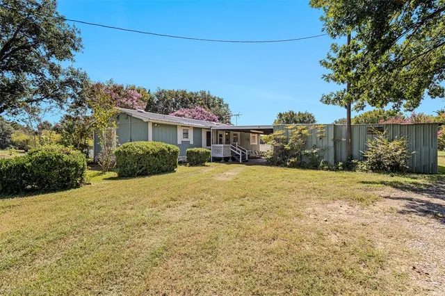 a view of a house with backyard and porch