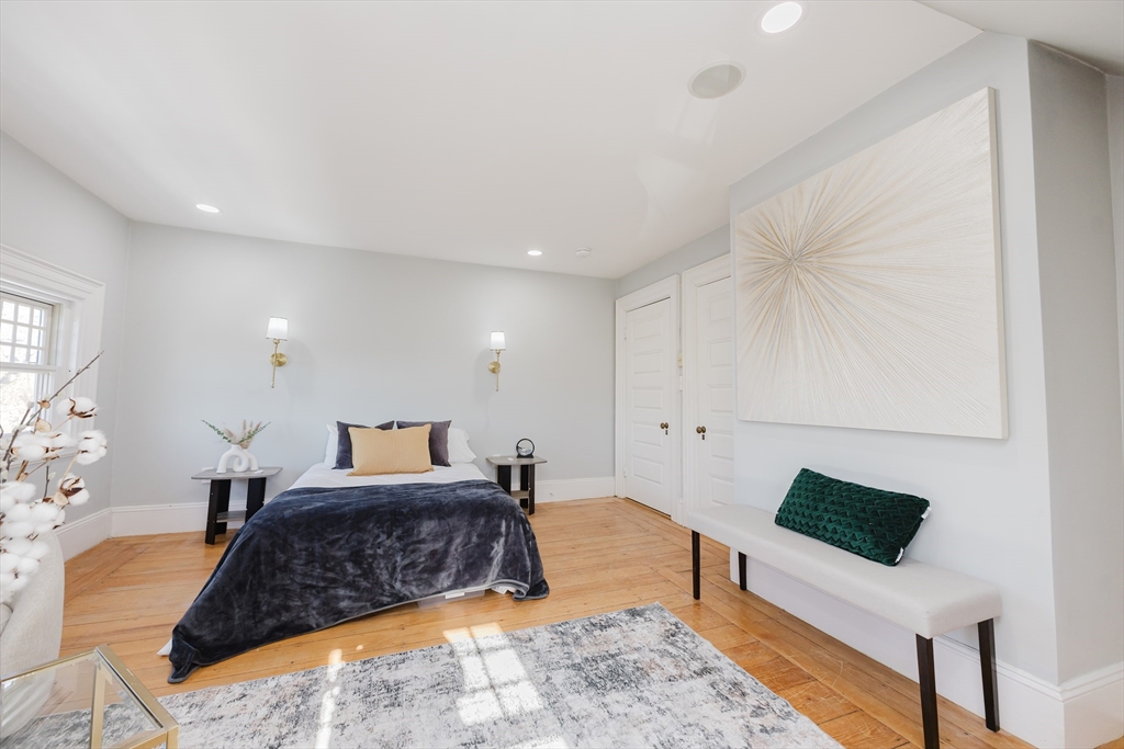 159 Washington Street, Unit 4 Newton, MA 02458 - Photo 15 of 41 a large bedroom with a bed and wooden floor