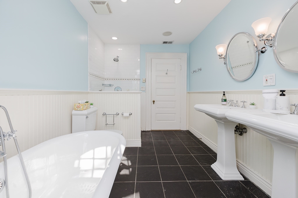 159 Washington Street, Unit 4 Newton, MA 02458 - Photo 19 of 41 a bathroom with a sink a toilet a mirror and vanity