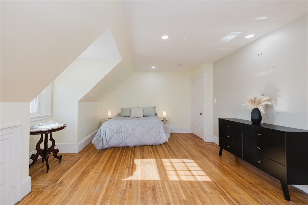 159 Washington Street, Unit 4 Newton, MA 02458 - Photo 23 of 41 a bedroom with a bed and a table