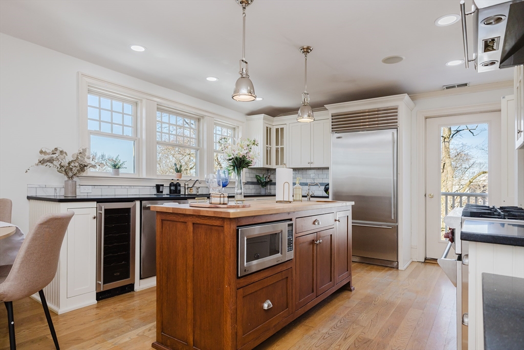 159 Washington Street, Unit 4 Newton, MA 02458 - Photo 28 of 41 a kitchen with kitchen island granite countertop a sink stove and refrigerator