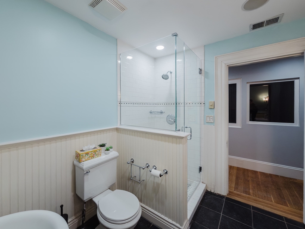 159 Washington Street, Unit 4 Newton, MA 02458 - Photo 41 of 42 a bathroom with a toilet a sink and mirror