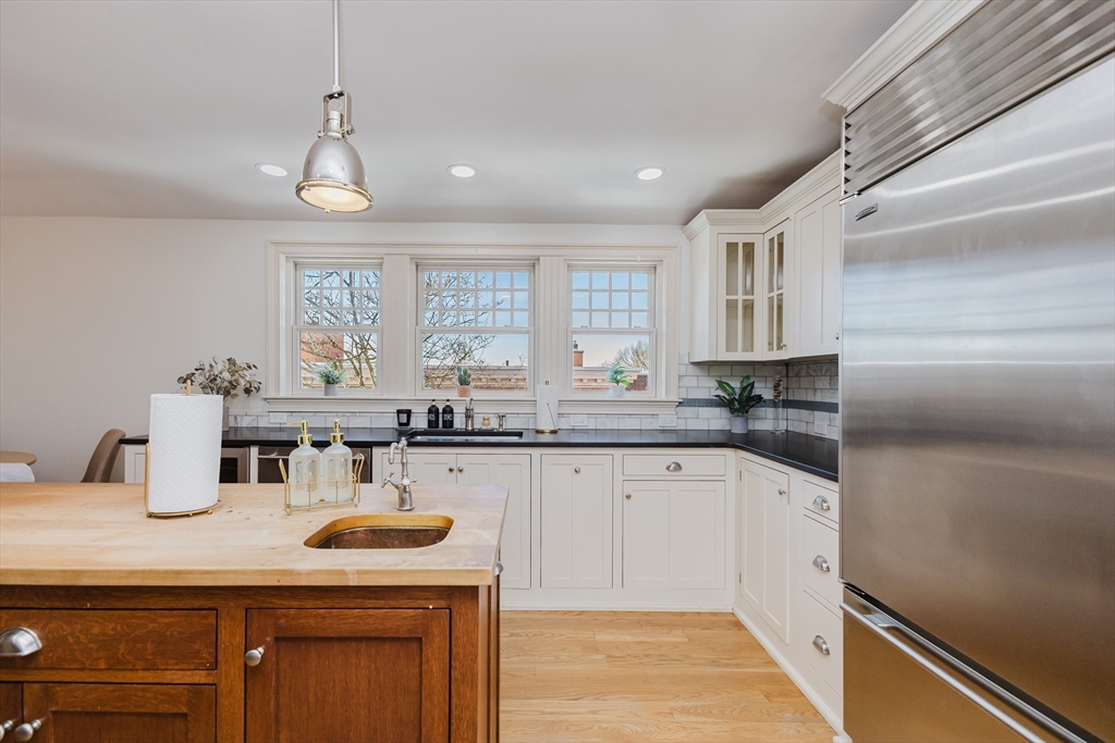 159 Washington Street, Unit 4 Newton, MA 02458 - Photo 6 of 41 a kitchen with sink cabinets and window