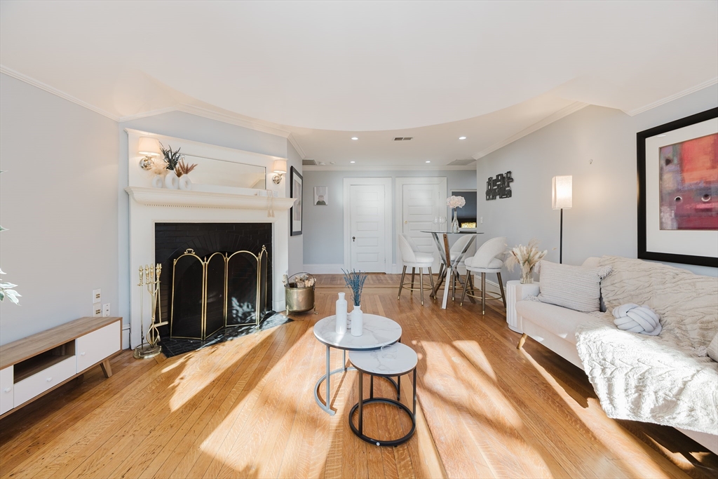 159 Washington Street, Unit 4 Newton, MA 02458 - Photo 9 of 41 a living room with furniture and a fireplace