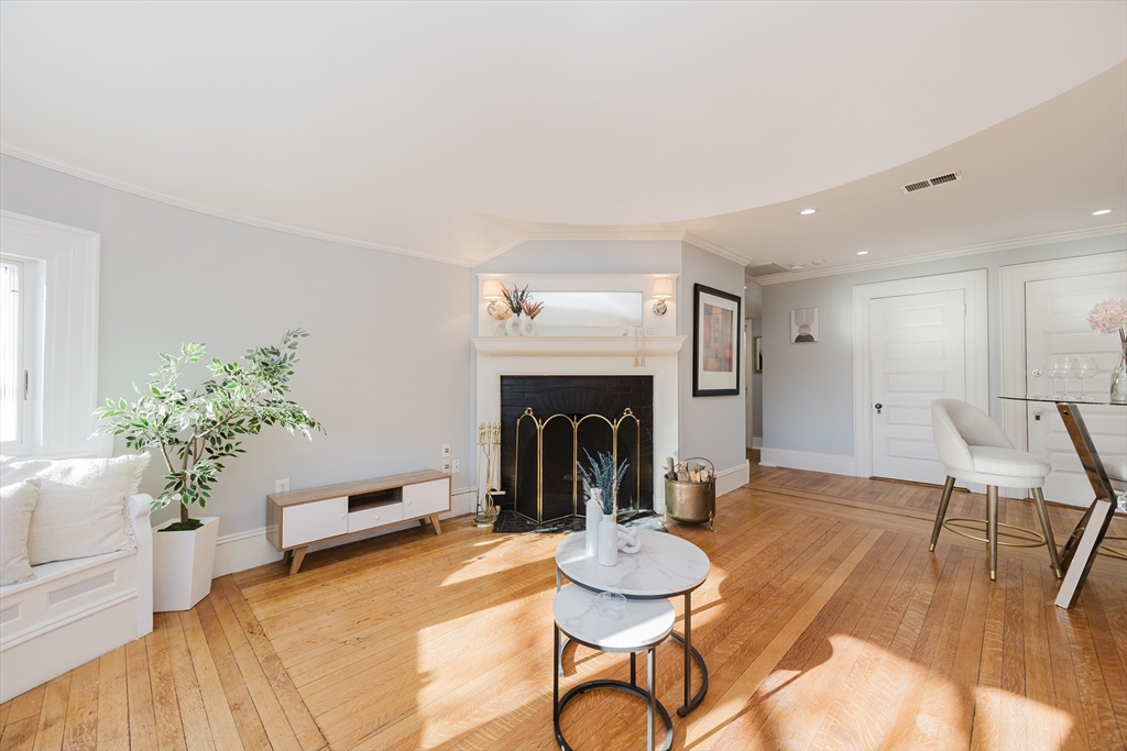 159 Washington Street, Unit 4 Newton, MA 02458 - Photo 10 of 41 a living room with furniture and a fireplace