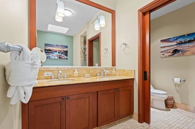 a bathroom with a sink a toilet and mirror