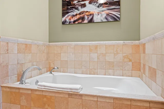 a bathroom with a bathtub and a shower