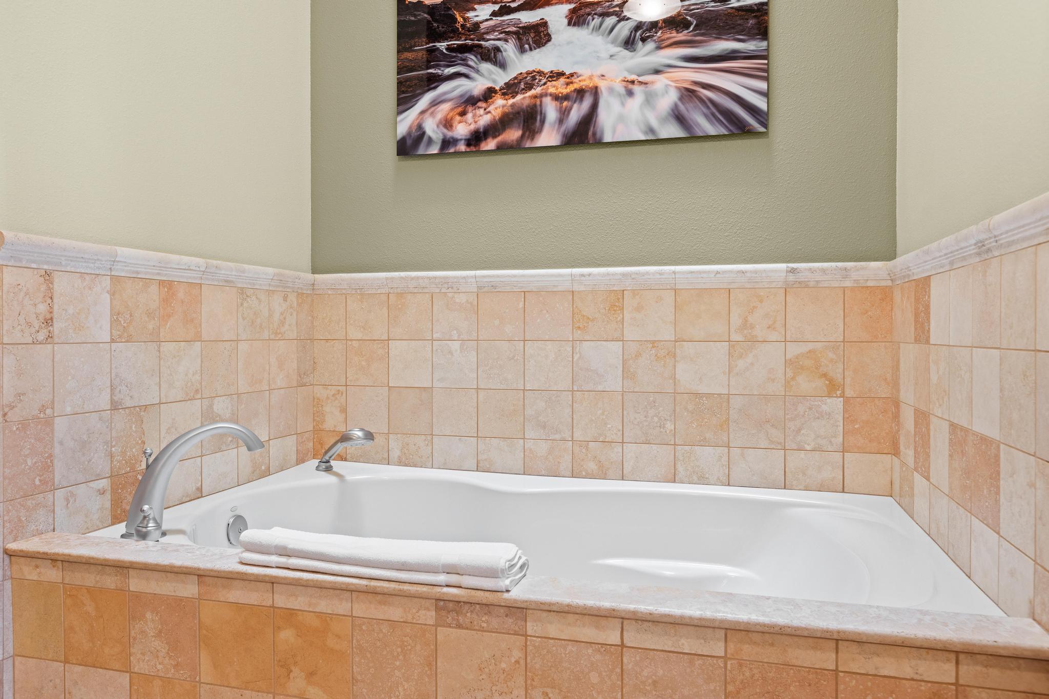 69-1000 Kolea Kai Circle, Unit 11C Waikoloa, HI 96738 - Photo 13 of 30 a bathroom with a bathtub and a shower