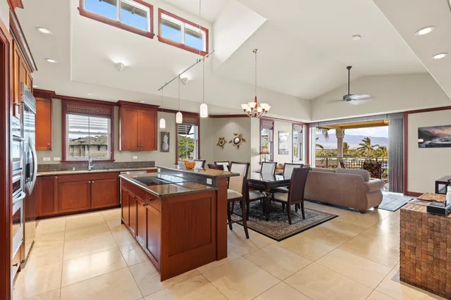 a large kitchen with kitchen island a large counter space and stainless steel appliances