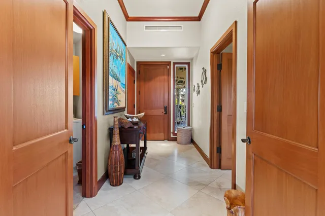 a view of a hallway with furniture and a window