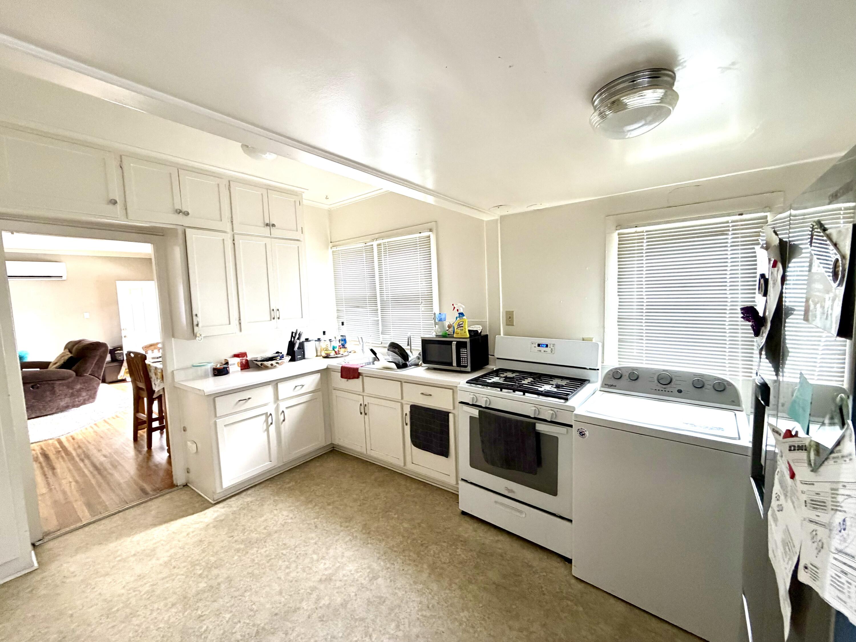 200 North B Street Exeter, CA 93221 - Photo 7 of 20 a kitchen with a stove sink and a refrigerator