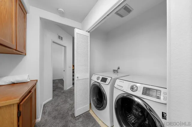 a view of storage and utility room with washer and dryer