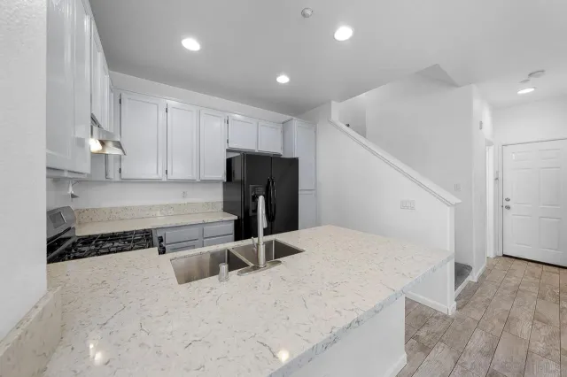 a kitchen with a refrigerator and a sink