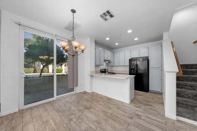 a kitchen with refrigerator and window