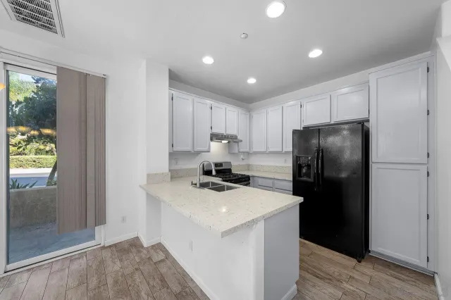 a kitchen with a refrigerator a stove top oven a refrigerator and a window