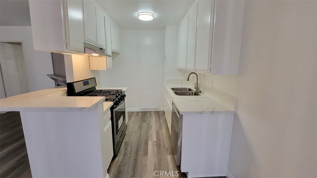 14817 Sylvan Street, Unit 3 Van Nuys, CA 91411 - Photo 5 of 12 a bathroom with a sink a mirror and shower
