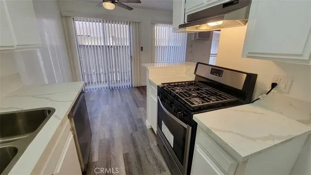 a kitchen with wooden cabinets and a stove top oven