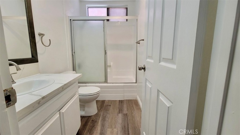 14817 Sylvan Street, Unit 3 Van Nuys, CA 91411 - Photo 9 of 12 a bathroom with a sink a toilet and shower