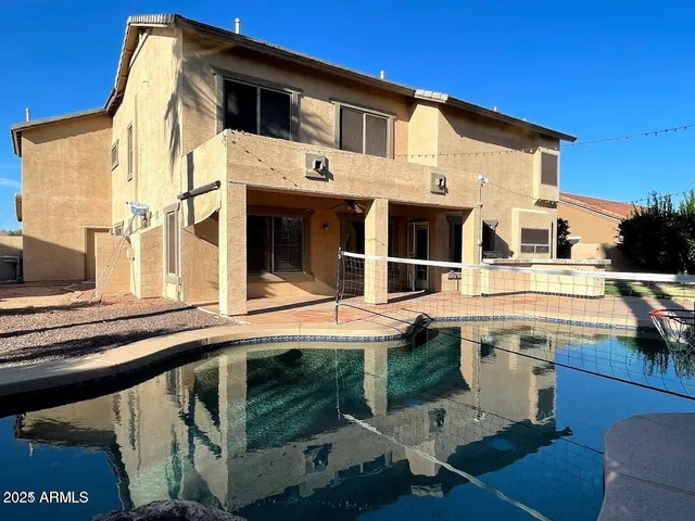 a view of a white house with large windows