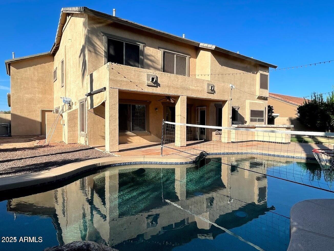 3235 East Devonshire Court Gilbert, AZ 85297 - Photo 1 of 28 a view of a white house with large windows