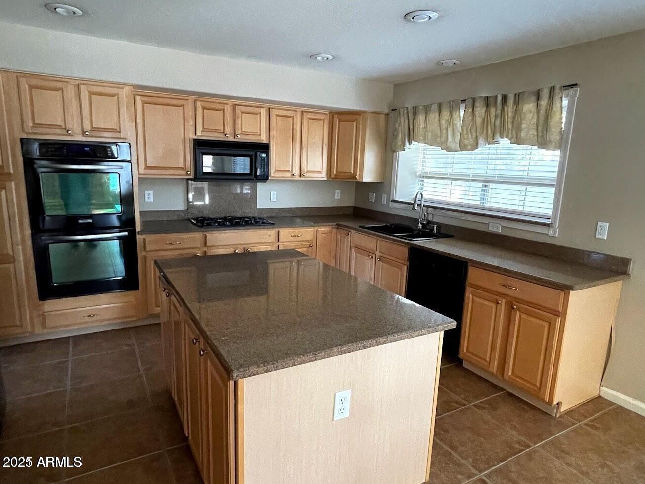 3235 East Devonshire Court Gilbert, AZ 85297 - Photo 16 of 28 a kitchen with granite countertop a stove top oven microwave and cabinets