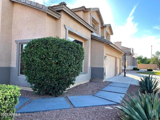 a view of a house with backyard and sitting area