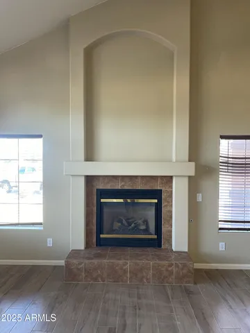 a living room with a fireplace and a window