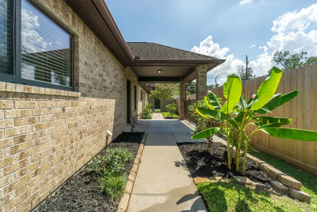 a view of a pathway with flower plants