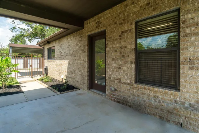 a front view of a house with basket ball court and outdoor seating