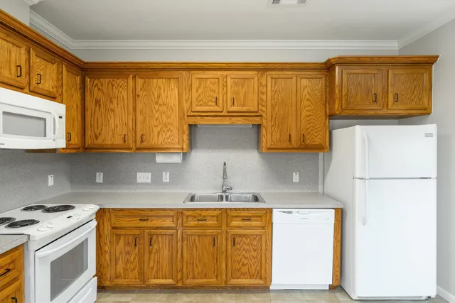a kitchen with stainless steel appliances granite countertop a refrigerator and a stove top oven