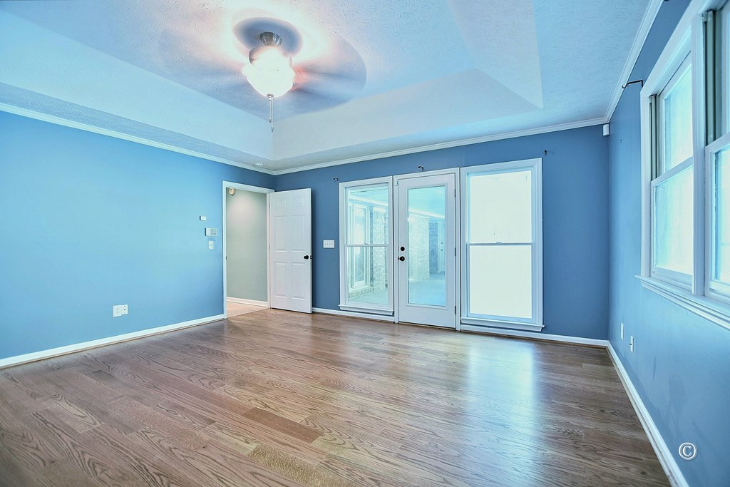 8935 K Moore Road Columbus, GA 31904 - Photo 17 of 36 a view of an empty room with a window and wooden floor