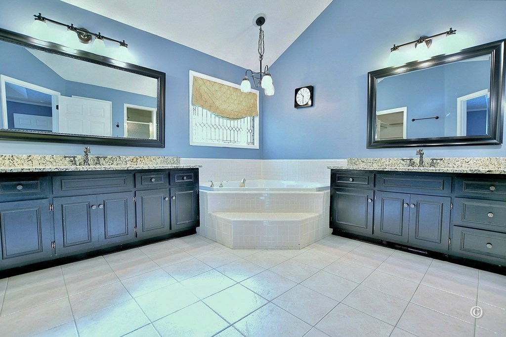 8935 K Moore Road Columbus, GA 31904 - Photo 18 of 36 a bathroom with a tub sink and mirror
