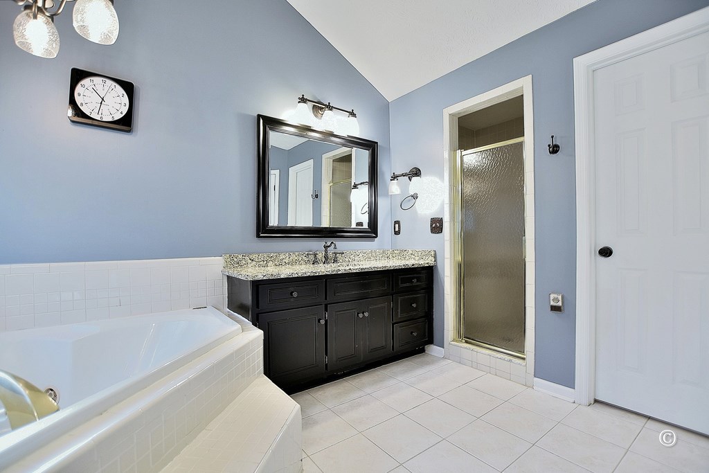8935 K Moore Road Columbus, GA 31904 - Photo 20 of 36 a bathroom with a tub sink and mirror